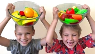 Kids Vania and Mania play with fruits and vegetables